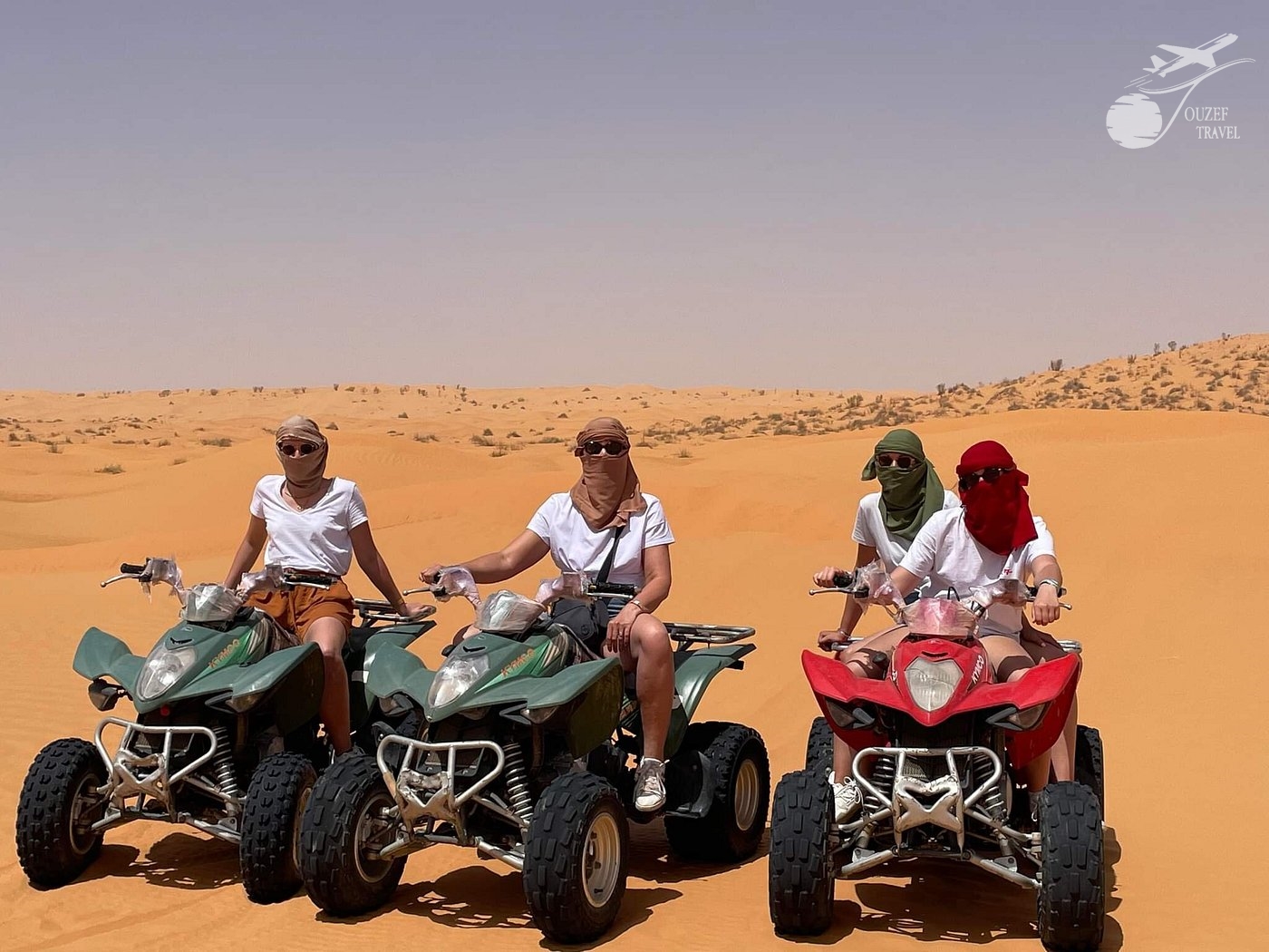 Guest riding a quad bike through the sandy dunes of Ksar Ghilane during the Djerba Sahara Tour